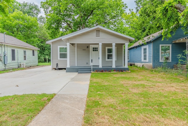 bungalow featuring a porch and a front lawn