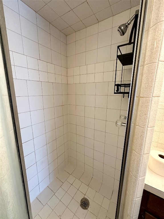 bathroom featuring vanity and tiled shower