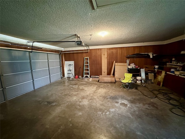 garage featuring wooden walls and a garage door opener