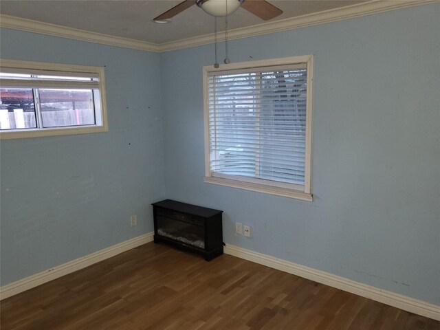 empty room with ceiling fan, dark hardwood / wood-style flooring, and crown molding