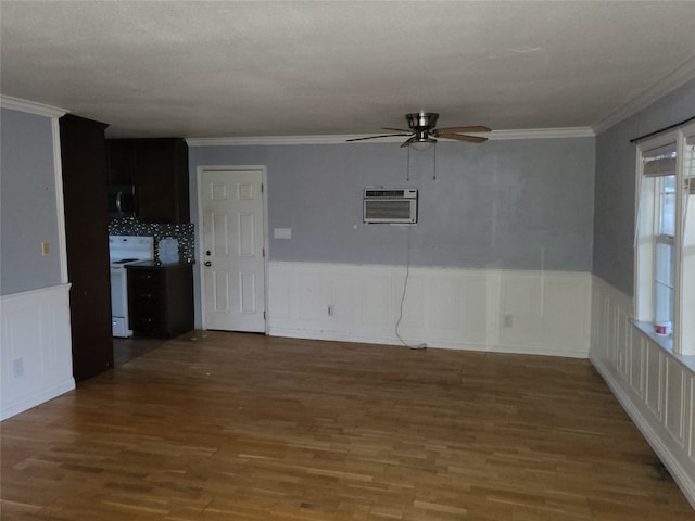 spare room featuring a wall mounted AC, dark hardwood / wood-style flooring, and ornamental molding