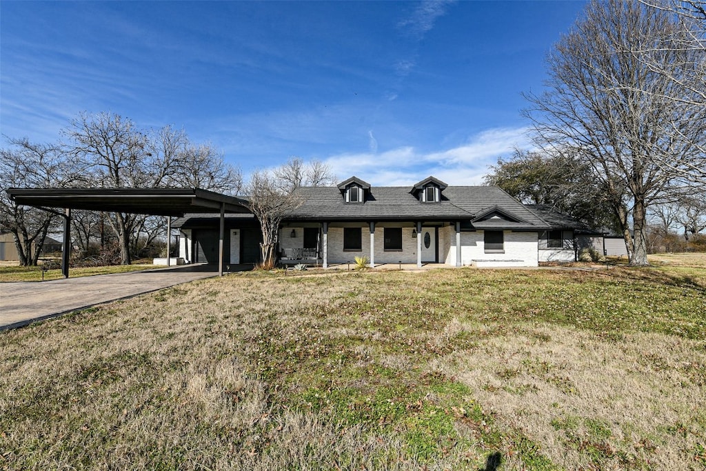 view of front of property with a front lawn and a carport