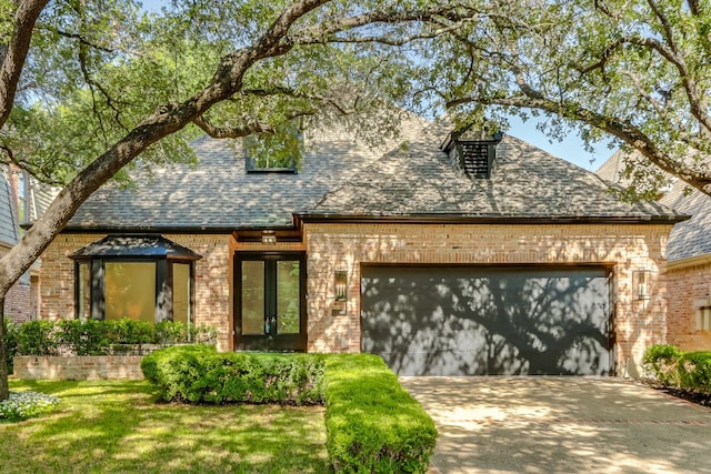 view of front of house with a garage and a front yard