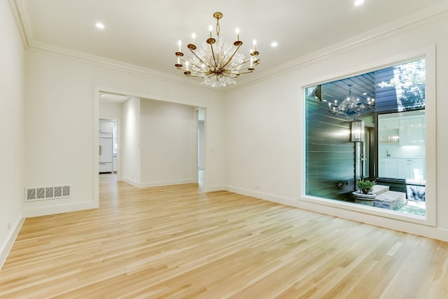 unfurnished room featuring crown molding, light hardwood / wood-style flooring, and a chandelier