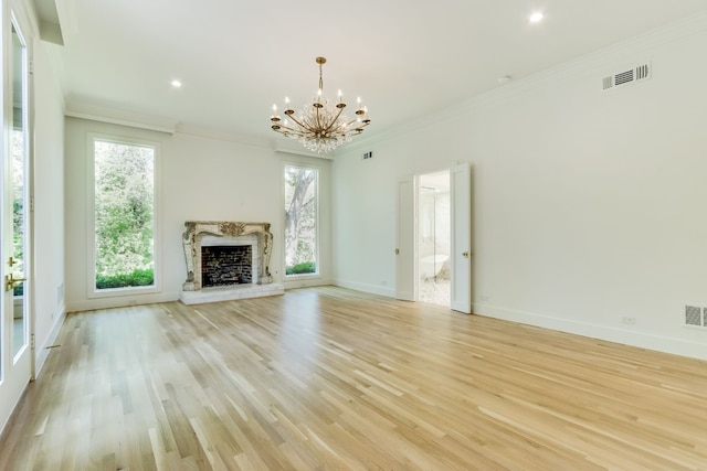 unfurnished living room with ornamental molding, a chandelier, and light wood-type flooring