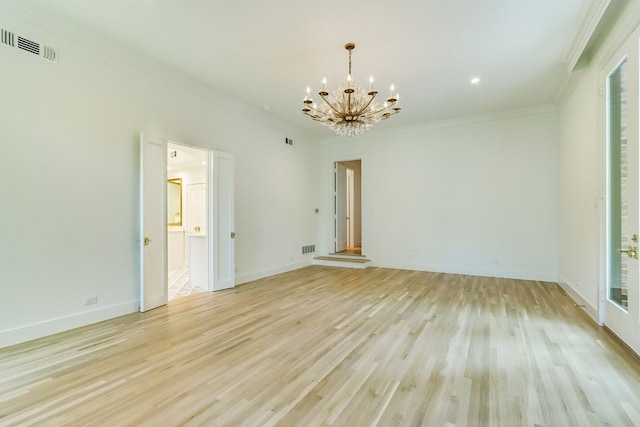 empty room with crown molding, a chandelier, and light hardwood / wood-style flooring