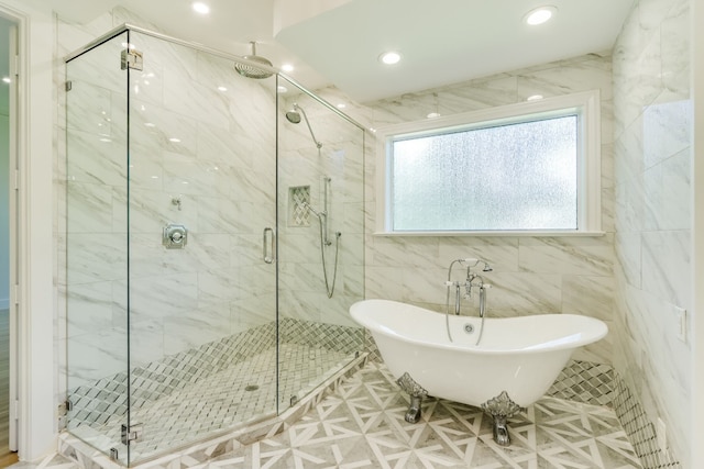 bathroom featuring tile walls and plus walk in shower