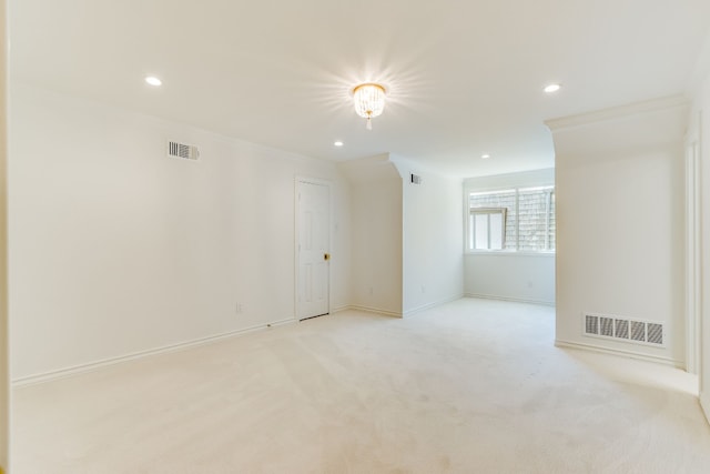 unfurnished room featuring light carpet and crown molding