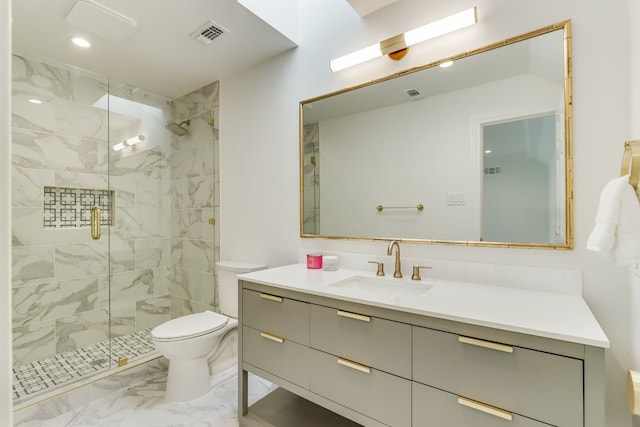 bathroom featuring vanity, a shower with door, and toilet