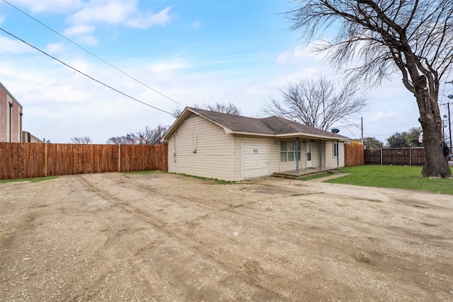 back of property featuring a lawn