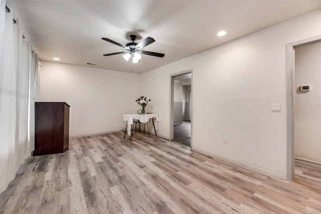 empty room with light hardwood / wood-style floors and ceiling fan