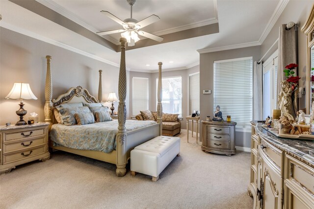 bedroom with ceiling fan, a raised ceiling, ornamental molding, and light carpet