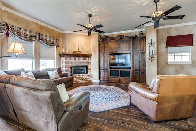 living room with crown molding, ceiling fan, and a brick fireplace