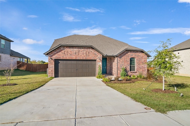 view of front facade featuring a front yard and a garage