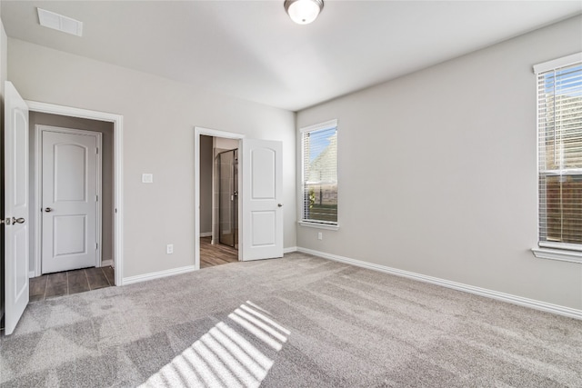 unfurnished bedroom featuring light carpet