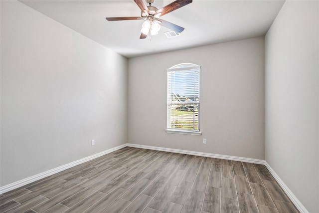 empty room featuring ceiling fan and hardwood / wood-style flooring