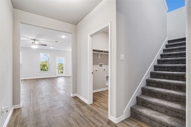 stairway featuring light hardwood / wood-style floors and ceiling fan