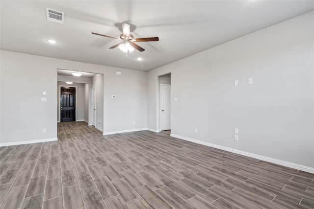 unfurnished room with ceiling fan and hardwood / wood-style flooring