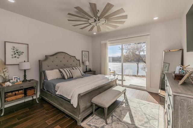 bedroom with ceiling fan, a water view, access to exterior, and dark hardwood / wood-style floors