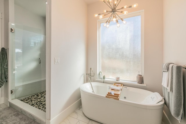 bathroom featuring tile flooring, independent shower and bath, plenty of natural light, and a notable chandelier