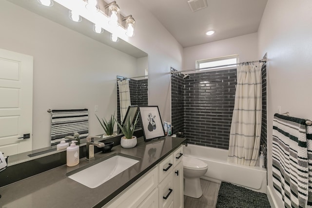 full bathroom with vanity, wood-type flooring, toilet, and shower / bath combo with shower curtain