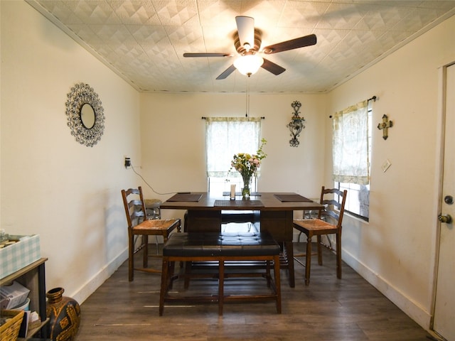 dining area with ornamental molding, ceiling fan, and dark wood-type flooring