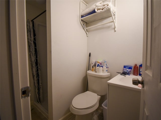 bathroom featuring vanity, a shower with shower curtain, and toilet