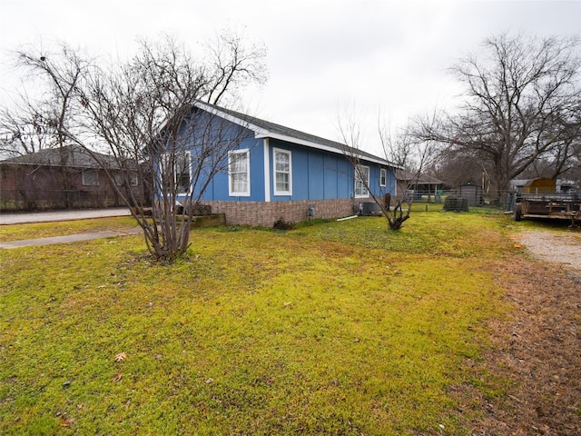 view of side of home featuring a yard