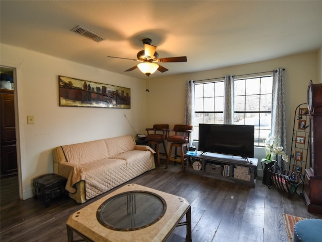 living room with dark hardwood / wood-style floors and ceiling fan