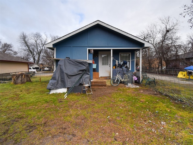 back of house featuring a lawn