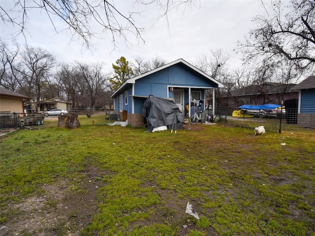 rear view of property with a yard