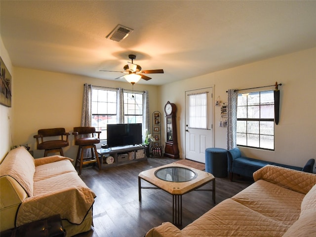 living room with plenty of natural light, dark hardwood / wood-style floors, and ceiling fan