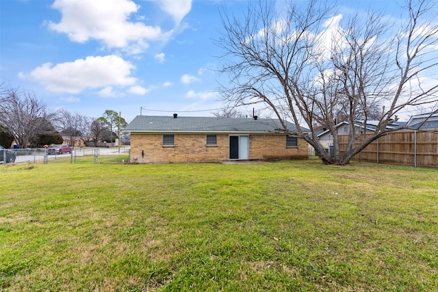 back of house with a lawn