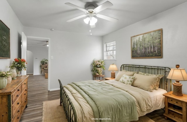 bedroom featuring ceiling fan and dark hardwood / wood-style flooring