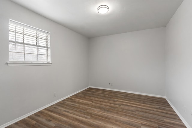 empty room featuring dark hardwood / wood-style flooring