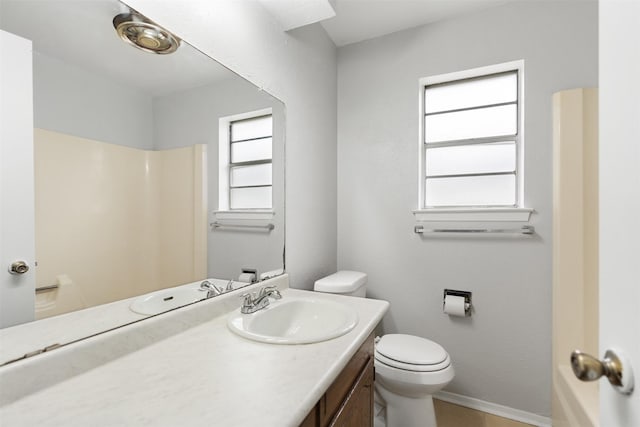 bathroom featuring walk in shower, tile patterned flooring, vanity, and toilet