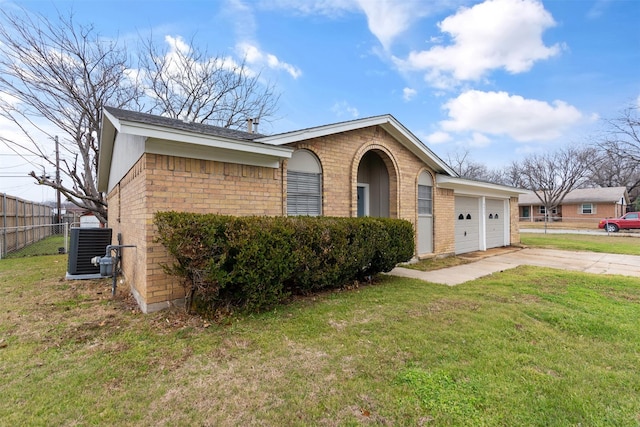 ranch-style house with cooling unit, a front yard, and a garage