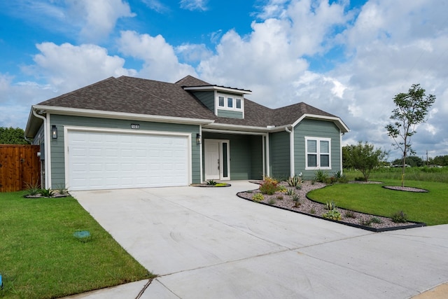 view of front of property featuring a garage and a front lawn