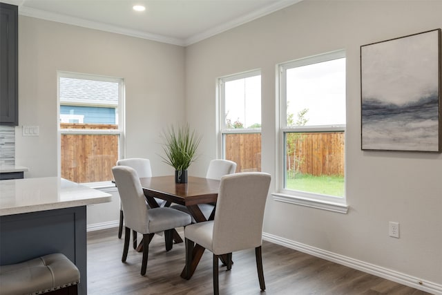 dining area featuring ornamental molding, hardwood / wood-style flooring, and a wealth of natural light