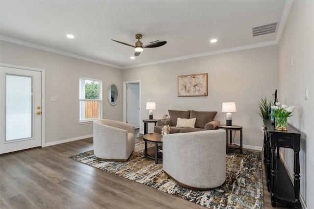 living room with ceiling fan, dark hardwood / wood-style flooring, and ornamental molding