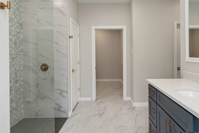 bathroom with tile patterned floors, vanity, and a tile shower