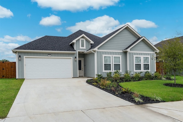 view of front of property featuring a garage and a front lawn