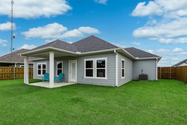 rear view of house featuring central AC, a yard, and a patio area