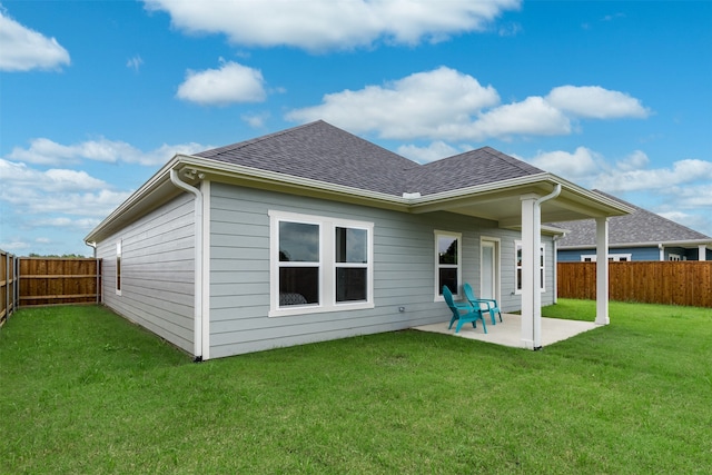 back of house featuring a yard and a patio area