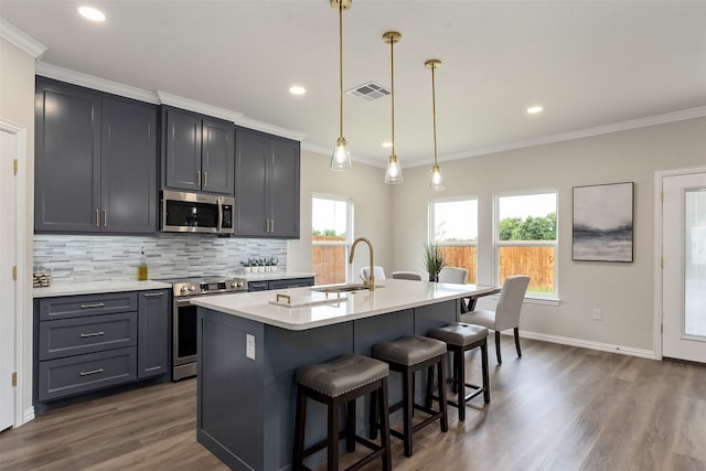 kitchen with appliances with stainless steel finishes, sink, decorative light fixtures, decorative backsplash, and dark hardwood / wood-style floors