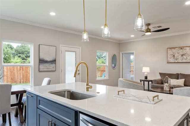 kitchen with pendant lighting, crown molding, hardwood / wood-style floors, sink, and light stone countertops