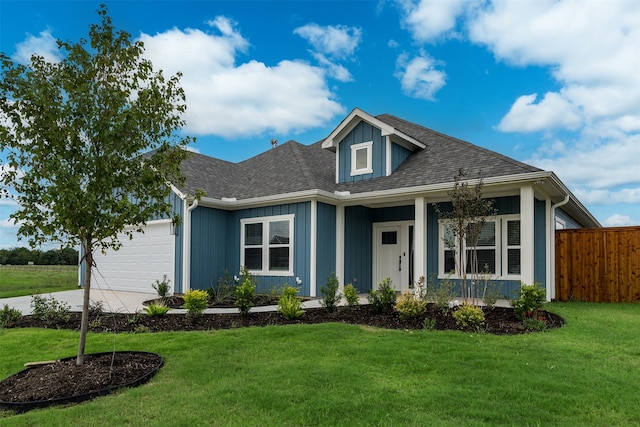 view of front of house with a garage and a front lawn