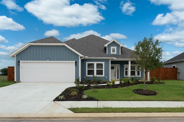 view of front of house featuring a garage and a front lawn