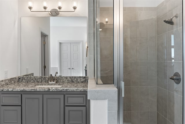 bathroom featuring vanity and a shower with door