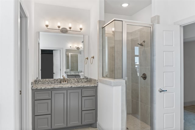 bathroom featuring vanity and an enclosed shower